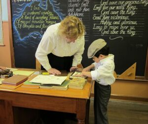 Museum teacher helping student use the jelly pad.