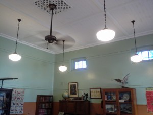 Ceiling of 1910 room showing lights, fan and gas vent.